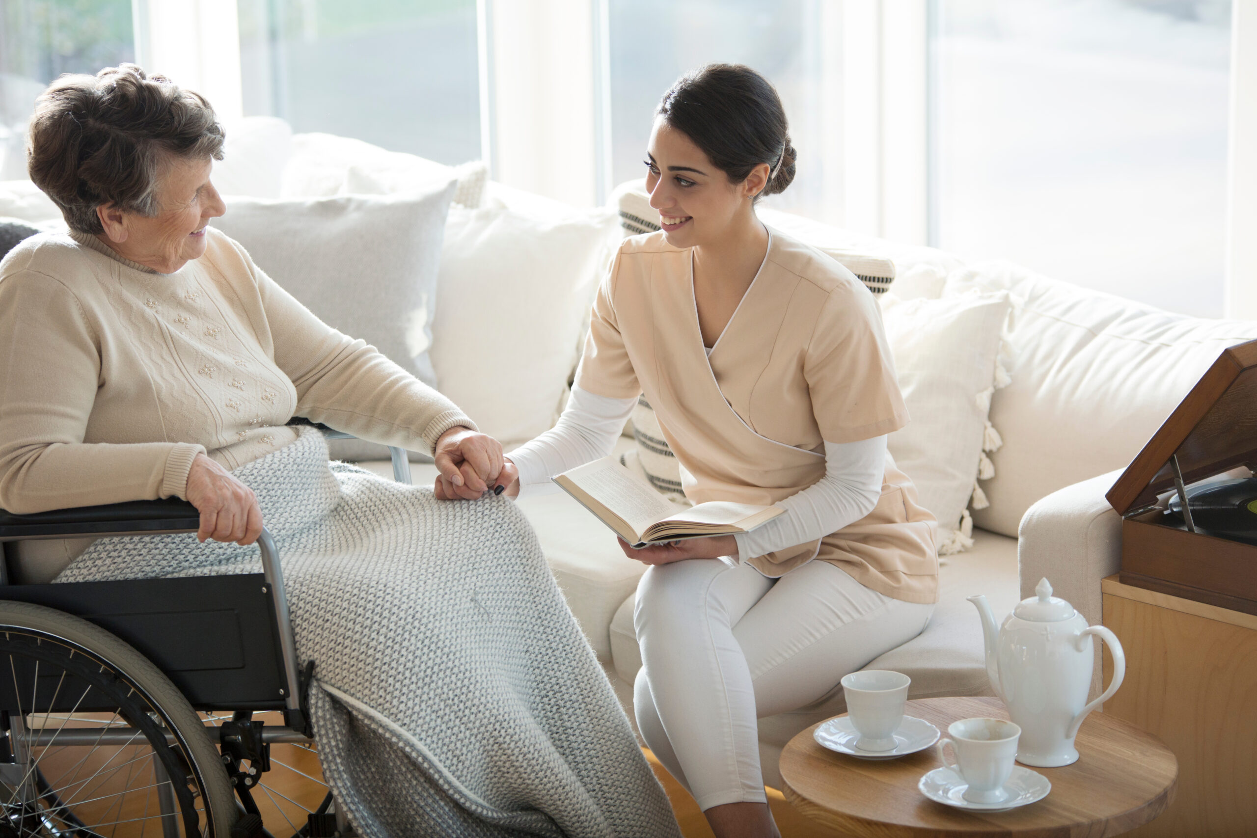 Acti-Kare – Home Care Compassionate caregiver providing home care in Kenmore, WA, assisting an elderly woman with companionship and daily activities.